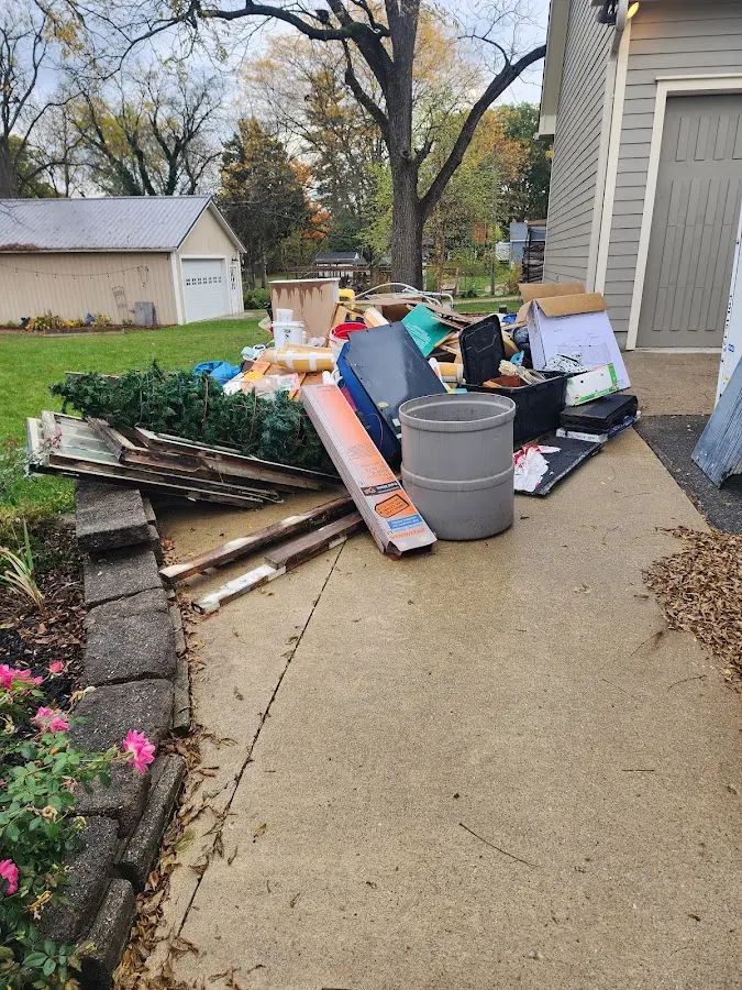 Dumpster being loaded with debris for Estate Cleanout Dumpster Rental in Irondale